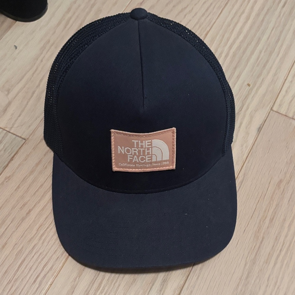 The North Face Blue Trucker Hat with Pink Logo